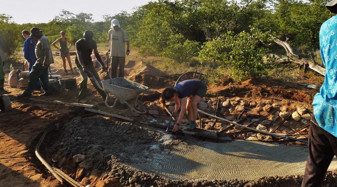 Transition Year volunteers help build a waterhole for wild animals during a drought in Botswana. A group of volunteers work to dig a waterhole to help animals during drought season during their Transition Year in Africa.